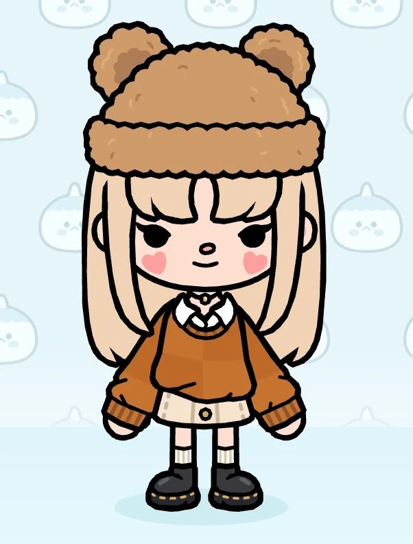 Fuzzy pom-pom beanie with rust knit sweater and pleated skirt